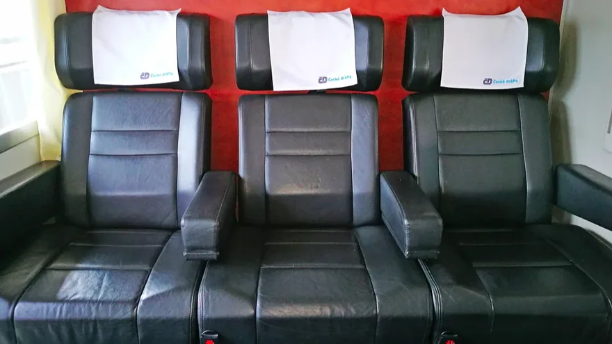 Railjet First and Business class on the Vienna to Prague train — black leather seats with České dráhy headrest covers