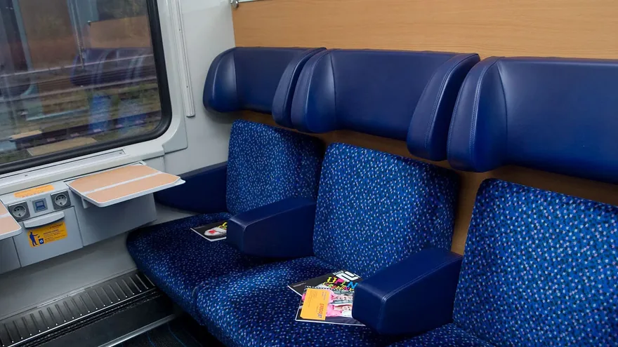 RegioJet Economy Plus class on the Vienna to Prague train — roomier dark-blue compartment seating